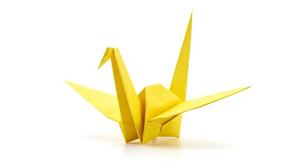 A yellow origami crane with detailed folds on a white surface