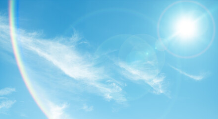 夏の晴天、青空に流れる積乱雲ふわふわの入道雲と輝く太陽のレンズフレア 夏・夏休み・行楽・バカンス・アウトドア・キャンプ・天気・台風一過・紫外線・日焼け 秋・秋晴れ