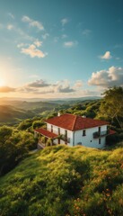 a charming white house with a terracotta roof sits nestled on a lush green hillside overlooking rolling mountains under a vibrant sky.