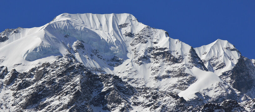 Peak of Naya Kanga covered by glacier and snow. View from Kyanjin Gumba, Langtang National Park, Nepal.