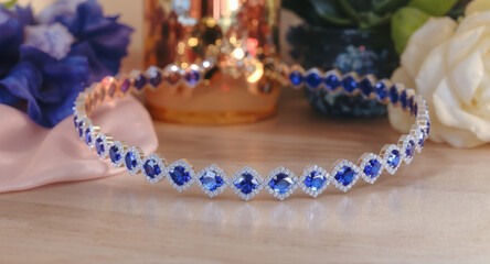 Elegant blue sapphire bracelet jewelry for luxury gift with romantic flower decor on wood table background