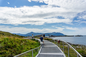 Tourists Capturing the Scenic Bridge on the Atlantic Ocean Road in West Norway