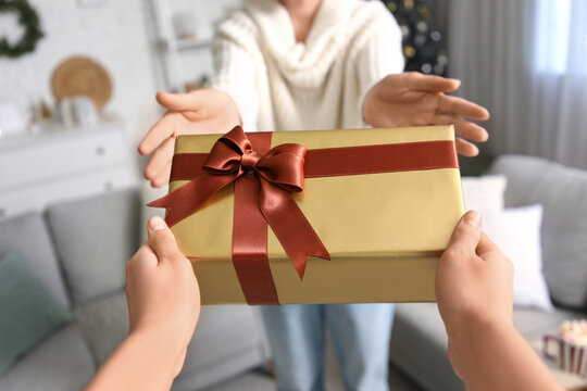 Woman with beautiful Christmas gift box at home, closeup - Powered by Adobe