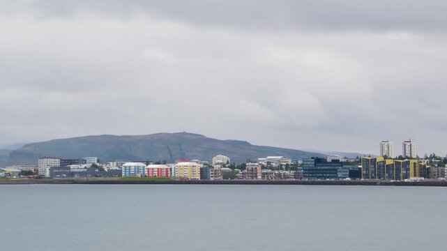 Reykjavik, Iceland. View of the Reykjavik, Iceland skyline during a cloudy summer day. Time-lapse, zoom in