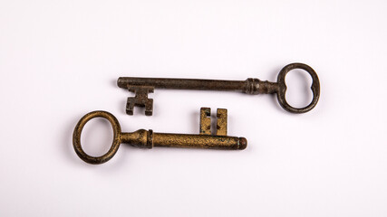 Two Vintage Metal Keys on White Background Symbolizing Security and History