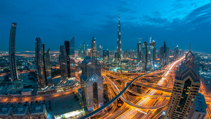 Modern skyscrapers and busy evening highways day to night timelapse in luxury Dubai city, Dubai, United Arab Emirates
