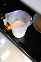 Baking preparation: measuring cup with flour mixture and spoon