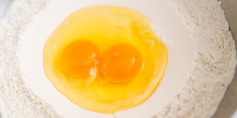 Double yolks in flour bowl for baking preparation