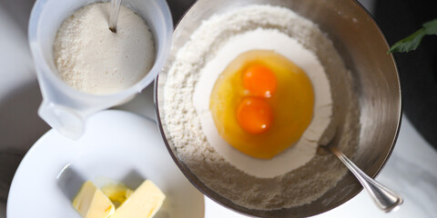 Baking ingredients for cake: eggs, flour, sugar, butter in kitchen preparation