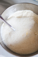 Mixing bowl with rising yeast dough for baking and bread making