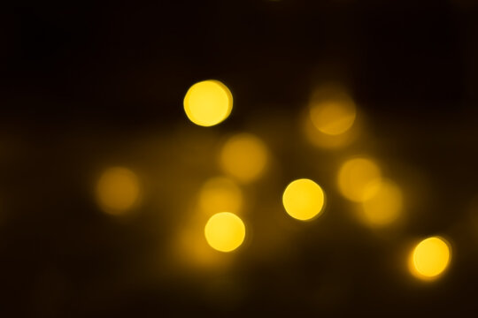 Yellow bokeh on a dark brown background
