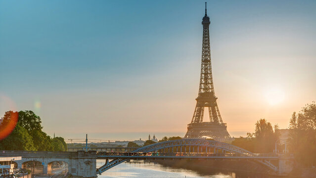 Eiffel Tower sunrise timelapse with boats on Seine river and in Paris, France.