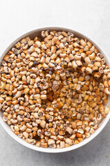 Overhead view of beans being washed, top view of honey beans being washed to make nigerian moi-moi or bean cake, process of peeling beans skin by hand
