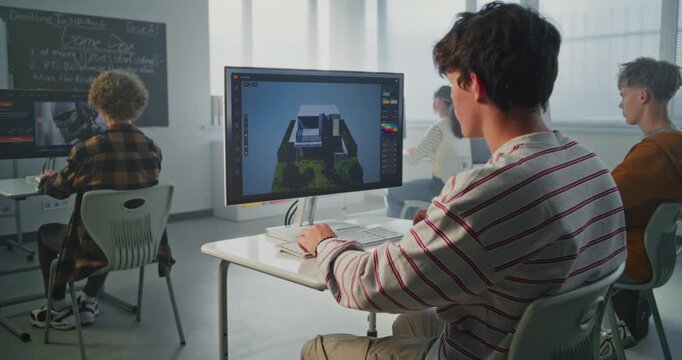 Young Man with Dark Hair Concentrates on 3D House Design at Computer in Classroom. Architectural Visualization, Creative Education. Concept of Digital Skills and Innovative Technologies. Static Shot.