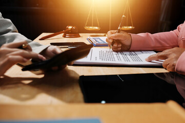 Consultation and conference of professional businesswoman and Male lawyers working and discussion having at law firm in office. Concepts of law, Judge gavel with scales of justice