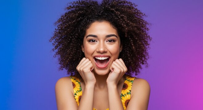 Excited woman with closed fists by her cheeks, joyful facial expression, colorful background, high quality studio portrait