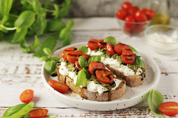 Italian sandwiches with grilled tomatoes, burrata cheese and pesto