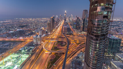 Obraz premium Scenic Dubai downtown skyline day to night timelapse. Rooftop view of Sheikh Zayed road