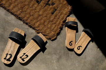Handmade wooden sandals. Indonesian traditional bakiak slippers with recycled rubber straps