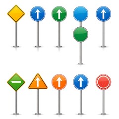 Road signs of various shapes and colors mounted on metal posts