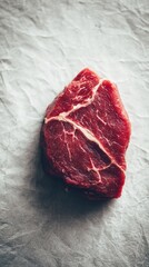 Fototapeta premium Blurred neutral background with soft warm tones, fresh raw beef steak on wooden board, highlighting marbling texture, minimal composition with copy space.