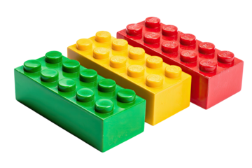 Three colorful rectangular blocks green, yellow, and red. Each block has studs on top, on a black backdrop