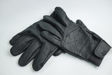 A sleek pair of black leather gloves casually laid on a clean white background. Perfect for concepts of style, protection, or a sophisticated fashion accessory.