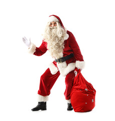 Santa Claus with bag full of gifts waving hand on white background