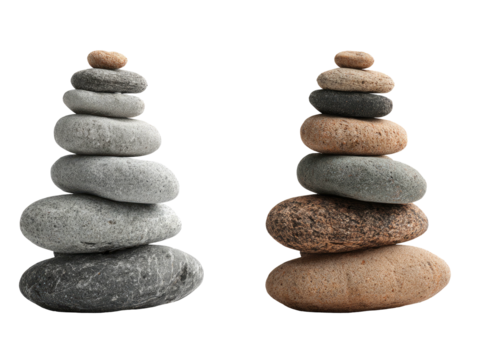 Two stacks of balanced stones of varying sizes and shades against a stark black background