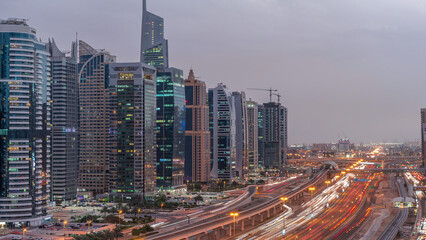 Fototapeta premium Aerial top view to Sheikh Zayed road near Dubai Marina and JLT day to night timelapse, Dubai.
