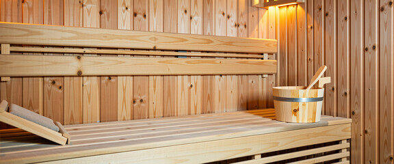 Interior of a traditional wooden sauna with bucket and ladle