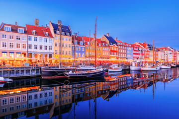 Copenhagen, Denmark. Nyhavn waterfront, colourful buliding facades and old ships along the canal.
