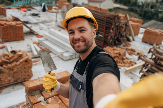 Making a selfie. A builder is working at the construction site at daytime