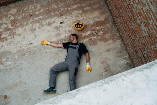 Man, construction worker fell from big height, lying down without consciousness, accident