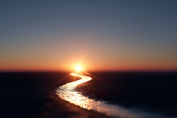 A sunset over the ocean with the sun setting in the distance