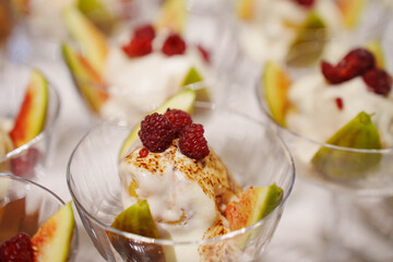 Delicious dessert cups with fresh fruit and cream served at a summer gathering