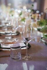 Stylish dining setup with elegant glassware and floral decorations
