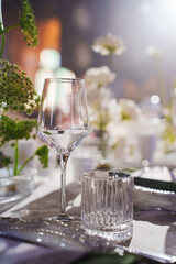 Elegant dining table setting with glassware and floral arrangements at night