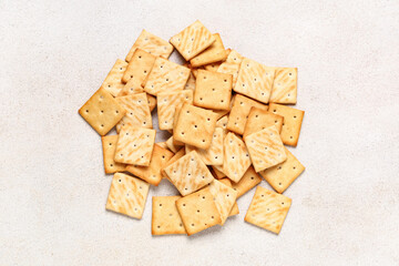 Heap of tasty crackers on beige grunge background