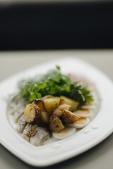 Traditional herring with potatoes greens and quail eggs rustic serving