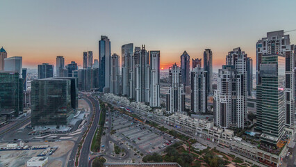 Modern residential and office complex with many towers aerial timelapse at Business Bay, Dubai, UAE.