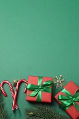 Festive scene with wrapped gifts, candies and decorations, sometimes on a green background, conveying Christmas greetings and celebration
