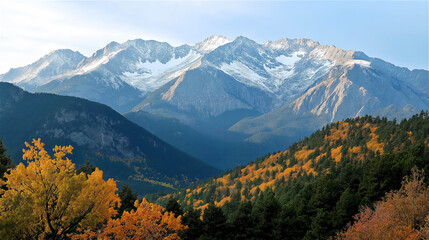 Beautiful mountain range under blue sky with golden autumn trees in the foreground. Tranquil travel or adventure scene perfect for nature and tourism visuals.