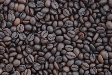 Pile of fresh roasted brown coffee beans close up. Food photo