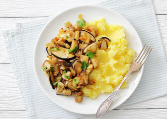 Fried porcini mushrooms with potato mash on plate