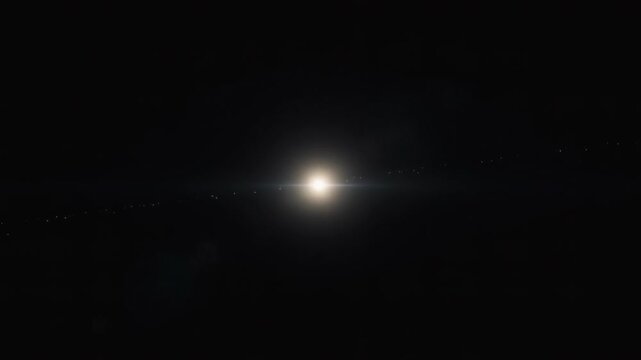 The camera locks onto a distant exoplanet system while the Sun slowly dims behind the horizon. A subtle lens flare follows as light bends through interplanetary dust