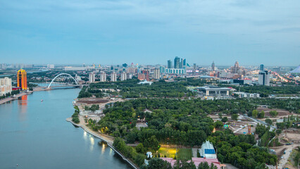Elevated view over the city center with river and park and central business district day to night Timelapse, Kazakhstan, Astana