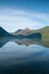 Morning view of Lower Multinskoye lake with Altai mountains mirroring in its water in the background, Russian Federation
