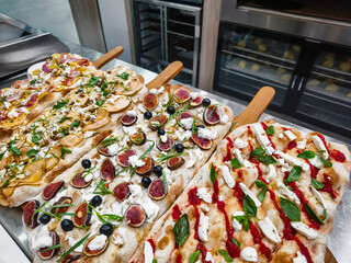 pizzas topped with fresh ingredients served at a modern eatery in the afternoon