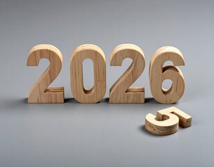 Slightly stylish wooden numbers '2026' placed on a smooth gray background, with an additional number '5' lying separately.